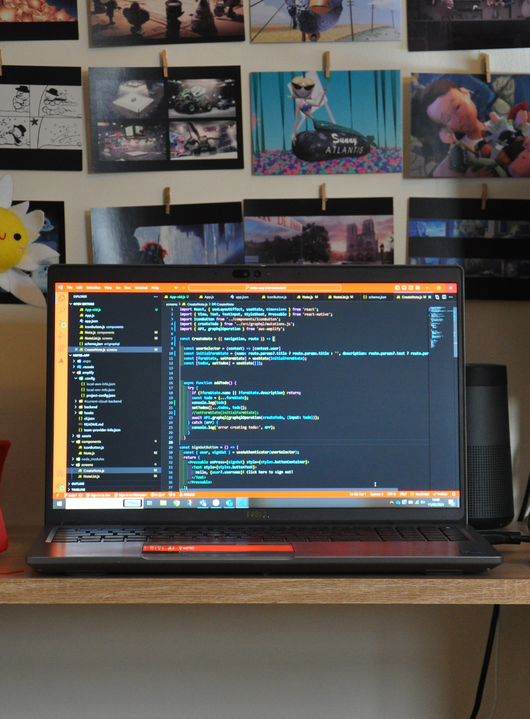 A laptop on a desk showing Visual Studio Code